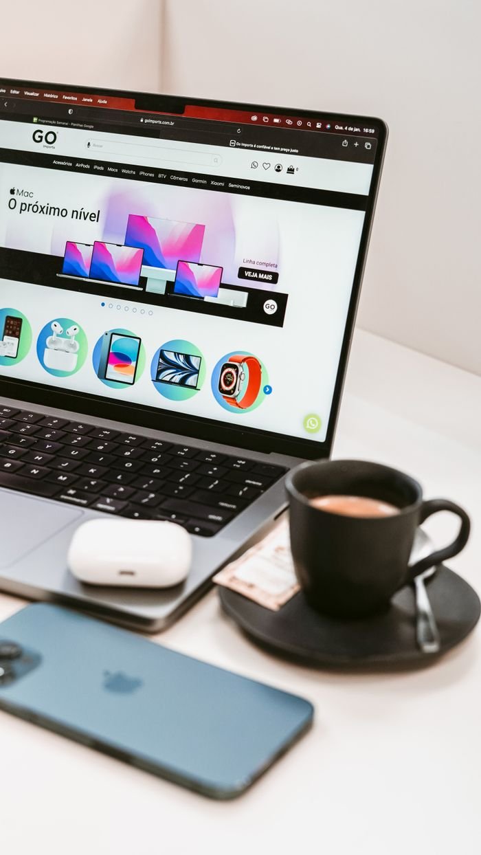 A stylish workspace featuring a laptop, smartphone, and coffee cup, embodying a modern tech lifestyle.