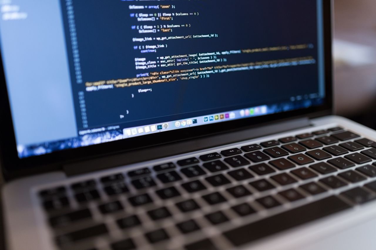 Home Focused view of programming code displayed on a laptop, ideal for tech and coding themes.